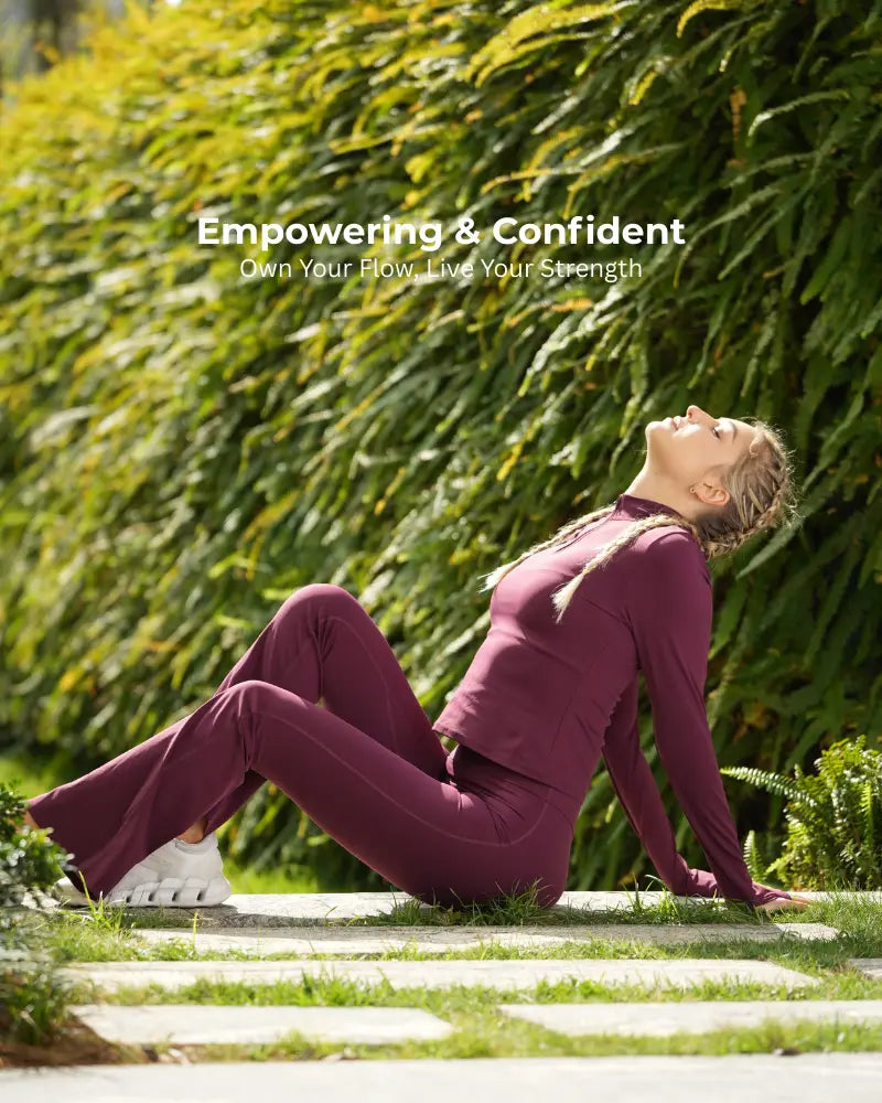 Woman in a purple outfit practicing yoga outdoors with text 'Empowering & Confident' and 'Own Your Flow, Live Your Strength'.