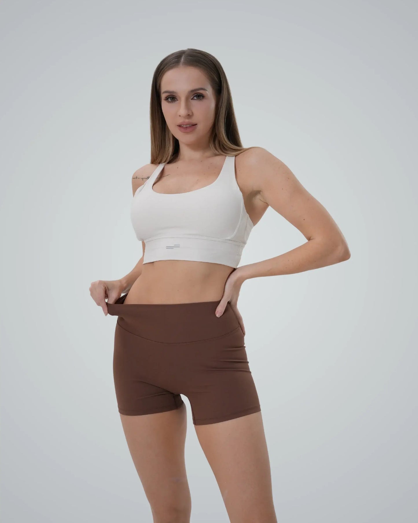 Woman wearing Bandsam Edge Pro Set, a seamless gym set with a supportive sports bra and high-waisted shorts, perfect for a trendy workout.