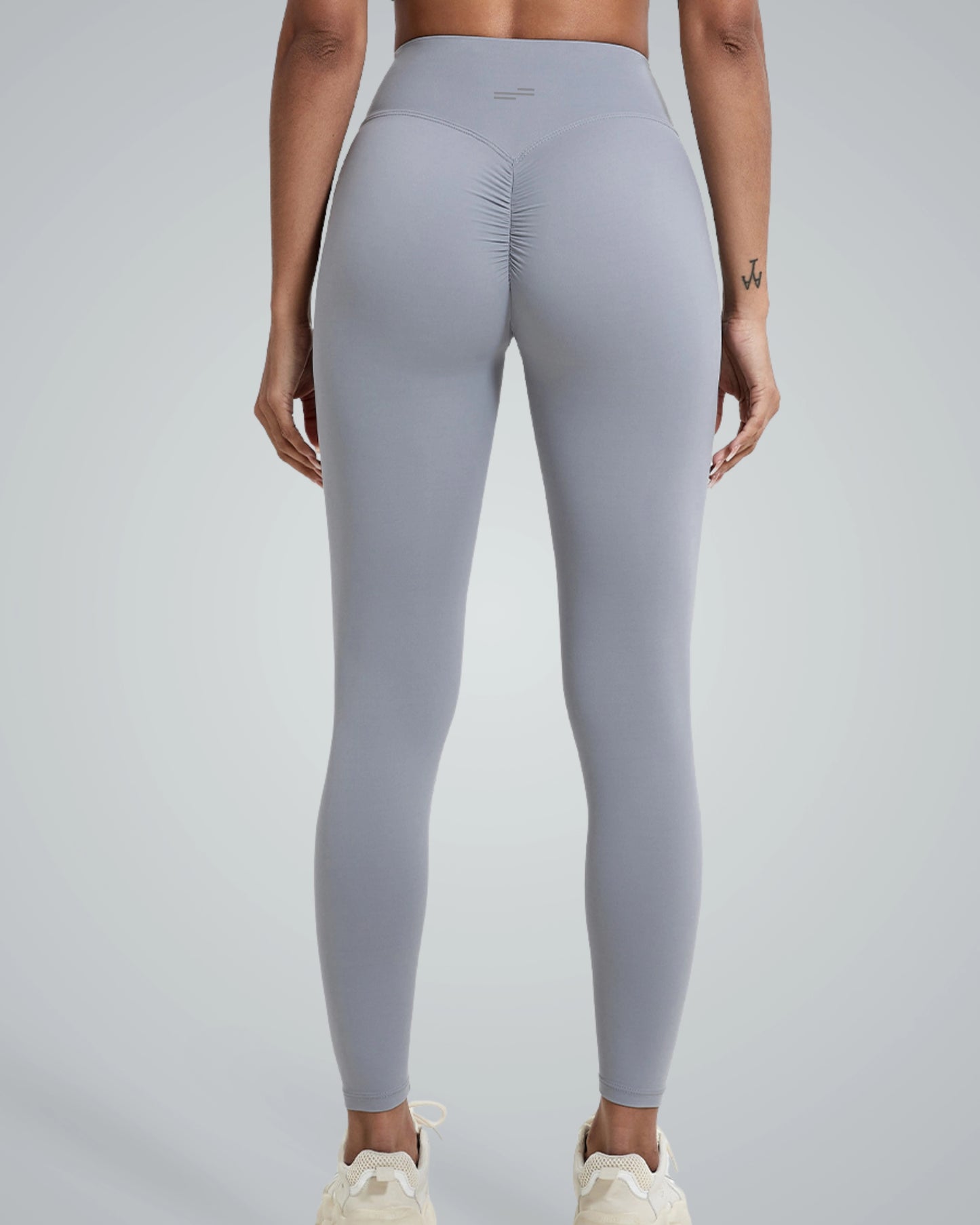 Woman wearing Bandsam Coral Crush Leggings, showcasing high-rise, scrunch-back feature; ideal for yoga, workout, and lounging in comfort.