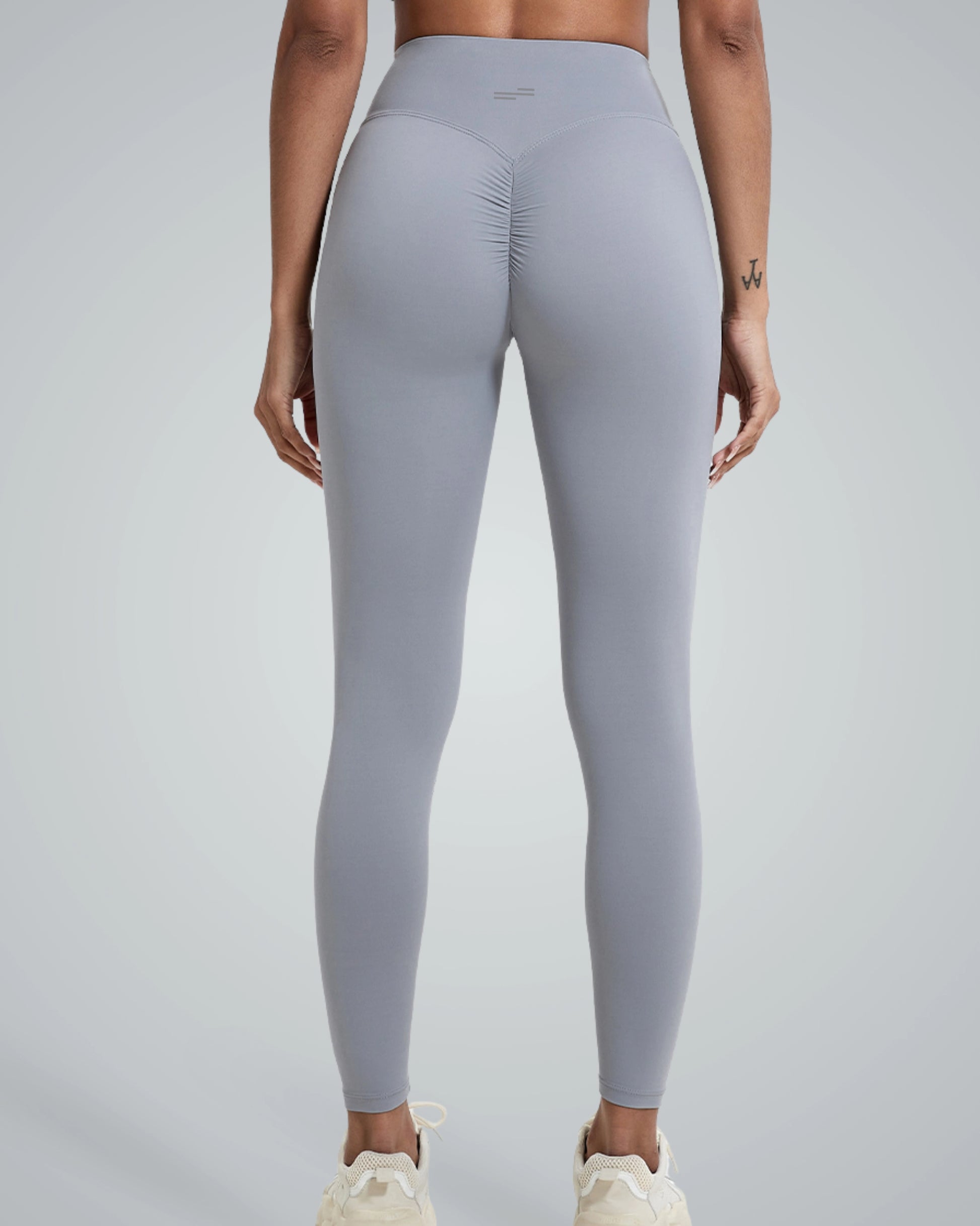 Woman wearing Bandsam Coral Crush Leggings, showcasing high-rise, scrunch-back feature; ideal for yoga, workout, and lounging in comfort.