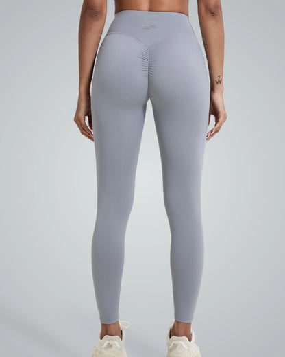 Woman wearing Bandsam Coral Crush Leggings, showcasing high-rise, scrunch-back feature; ideal for yoga, workout, and lounging in comfort.