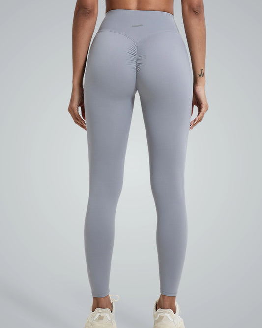 Woman wearing Bandsam Coral Crush Leggings, showcasing high-rise, scrunch-back feature; ideal for yoga, workout, and lounging in comfort.