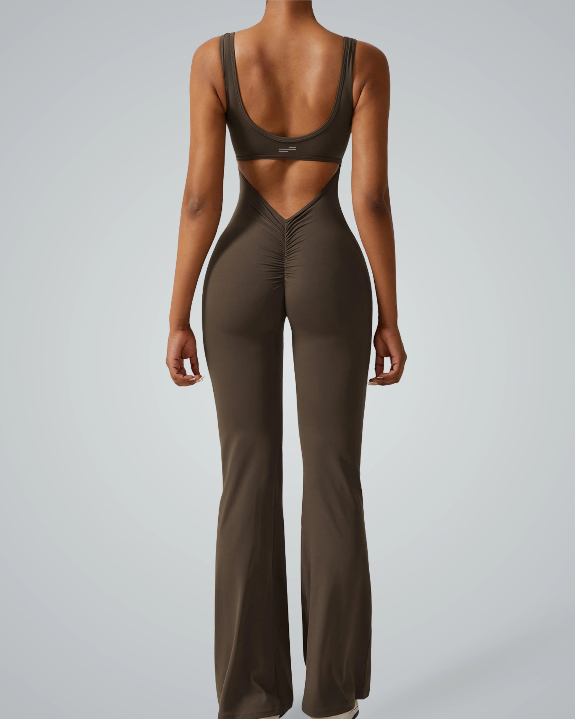 Woman wearing Bandsam AuraFlow Jumpsuit showcasing stretch, comfort, and flexibility for yoga, pilates, and lounging.
