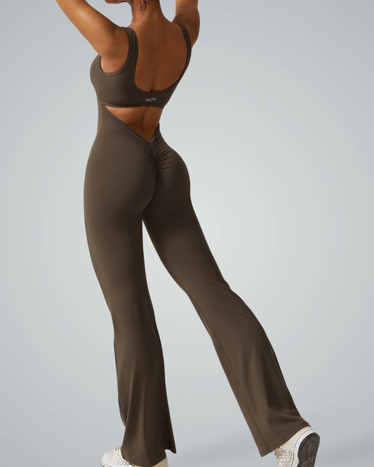 Back view of a woman in a brown Bandsam AuraFlow Jumpsuit, showcasing flared legs for yoga, pilates, and active lounging.