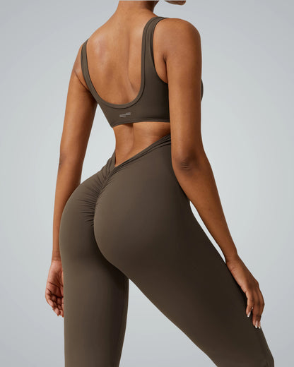 Back view of a woman wearing the Bandsam AuraFlow Jumpsuit, showcasing its stretch, support, and comfort for yoga, pilates, and lounging.