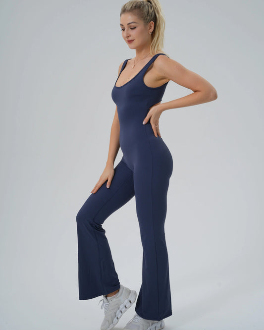 Woman wearing Bandsam AuraFlow Jumpsuit, showcasing stretch, comfort, and flexibility for yoga, pilates, lounging, and activewear.