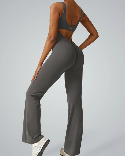 Woman wearing AuraFlow Jumpsuit by Bandsam, showcasing stretch, flexibility, and comfort for yoga, pilates, and lounging.