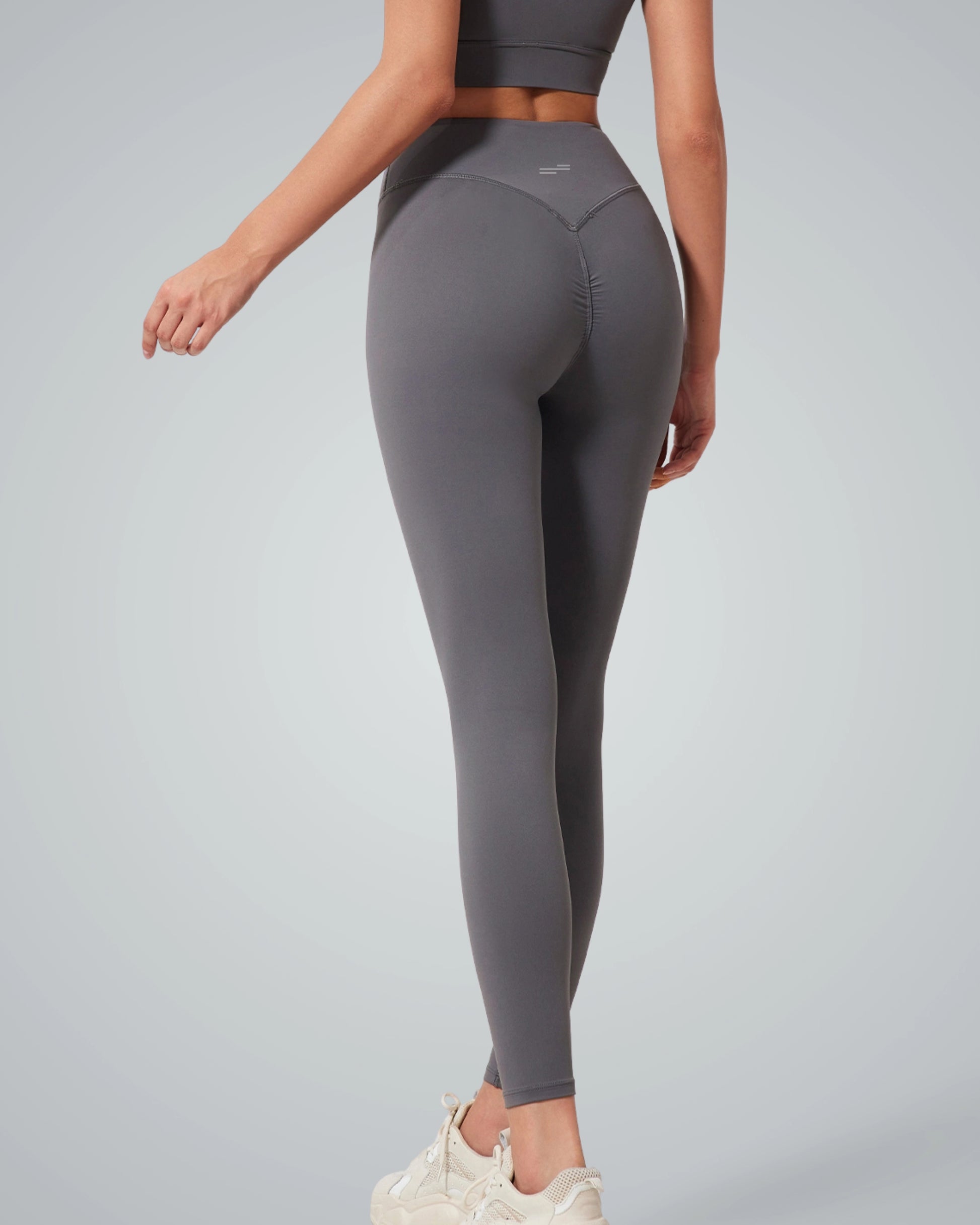 Woman wearing gray Bandsam Calm Wave Leggings for yoga, pilates, and lounging; stretch, comfort, and soft activewear for women.