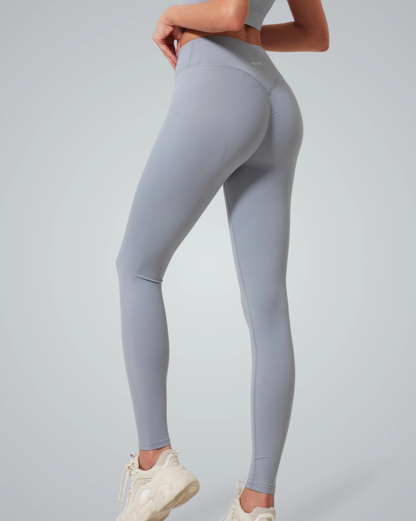 Woman wearing Bandsam Calm Wave Leggings, showcasing stretch and comfort for yoga, pilates, or lounging. High-rise design and soft fabric.