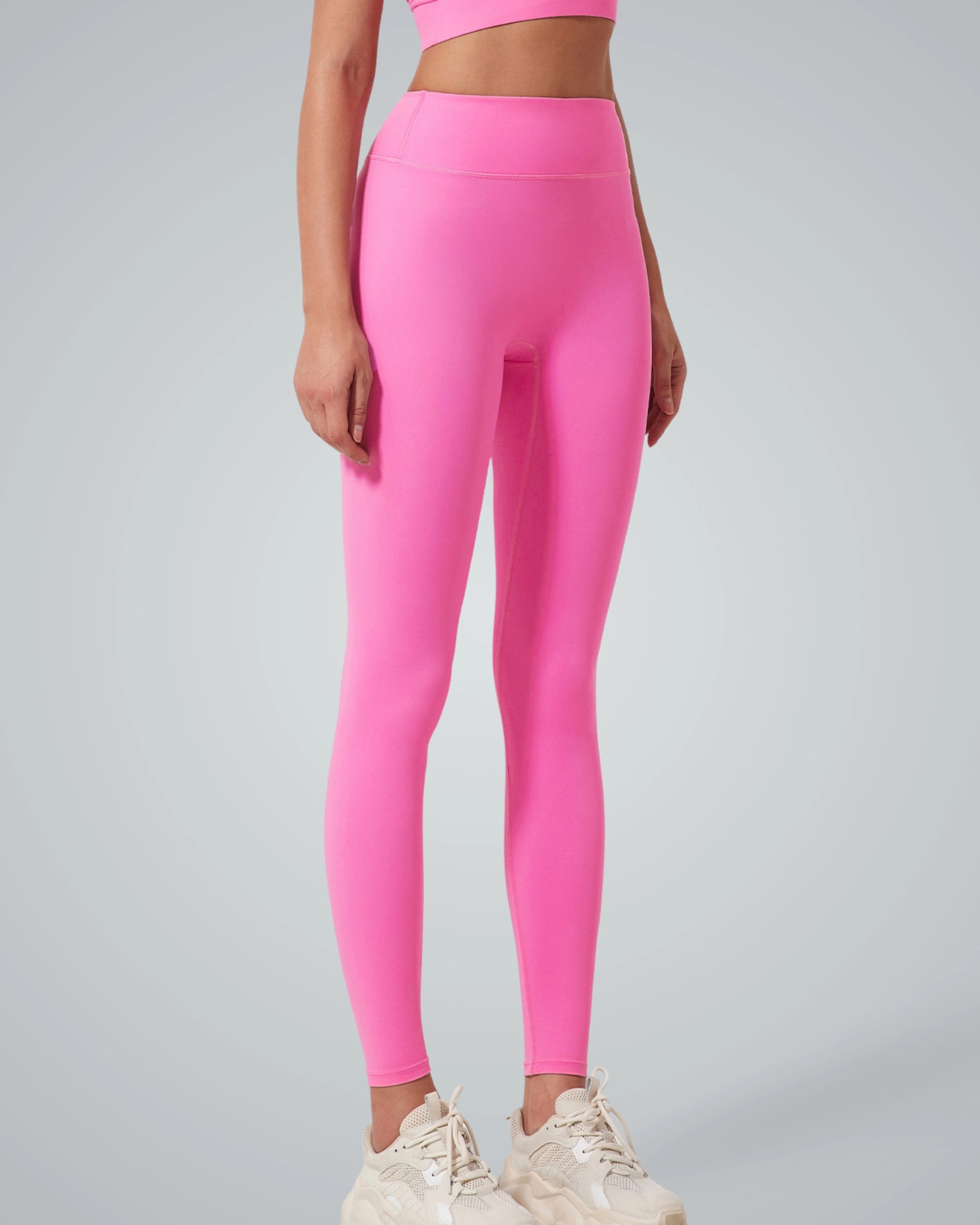 Woman wearing pink Bandsam Calm Wave Leggings, ideal for yoga, pilates, lounging, and outings. Stretchy, comfortable, and supportive activewear.