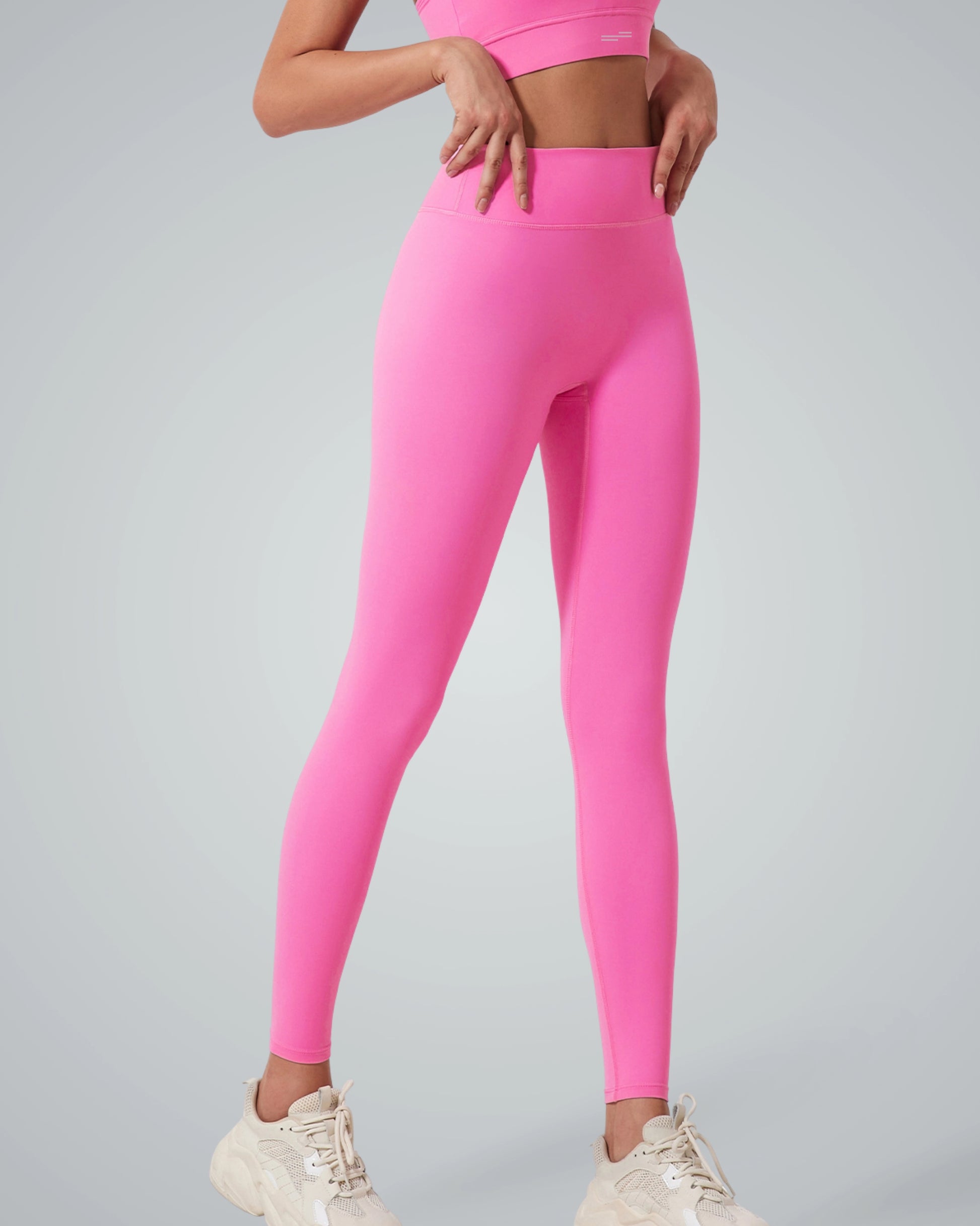 Woman wearing Bandsam Calm Wave Leggings in pink, perfect for workout, yoga, pilates, and relaxation. Stretchy, soft, supportive activewear.