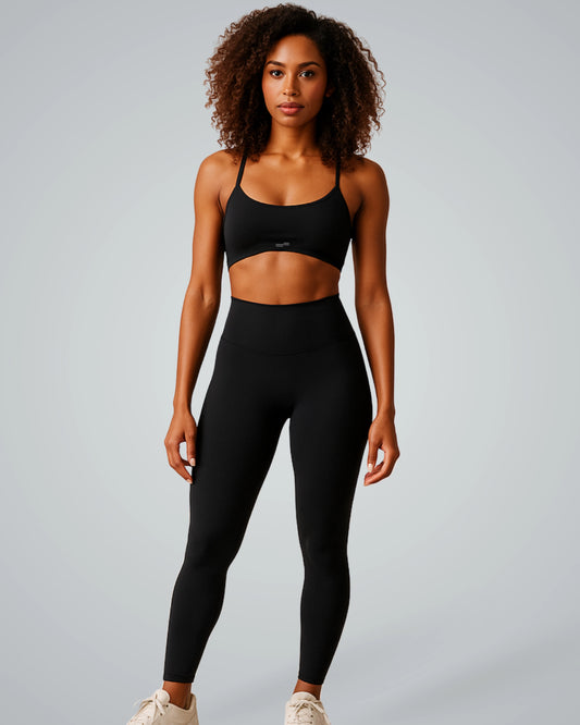 Woman wearing Bandsam ContourCore Set: seamless black sports bra and high-waisted leggings, perfect for chic and comfortable activewear.