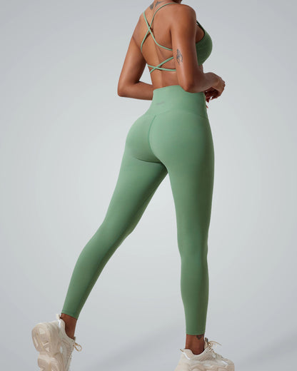 Woman wearing Bandsam ContourCore Set, a seamless gym outfit with high-waisted leggings and strappy sports bra in sage green.
