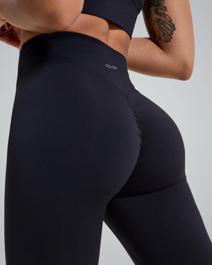 Back view of woman wearing black scrunch-back high-rise leggings by Bandsam, ideal for yoga, pilates, and lounging in stylish comfort.
