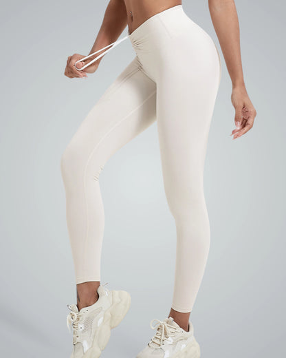 Women's high-rise leggings displayed in beige, showcasing a flexible and comfortable fit, ideal for yoga, pilates, and everyday wear.