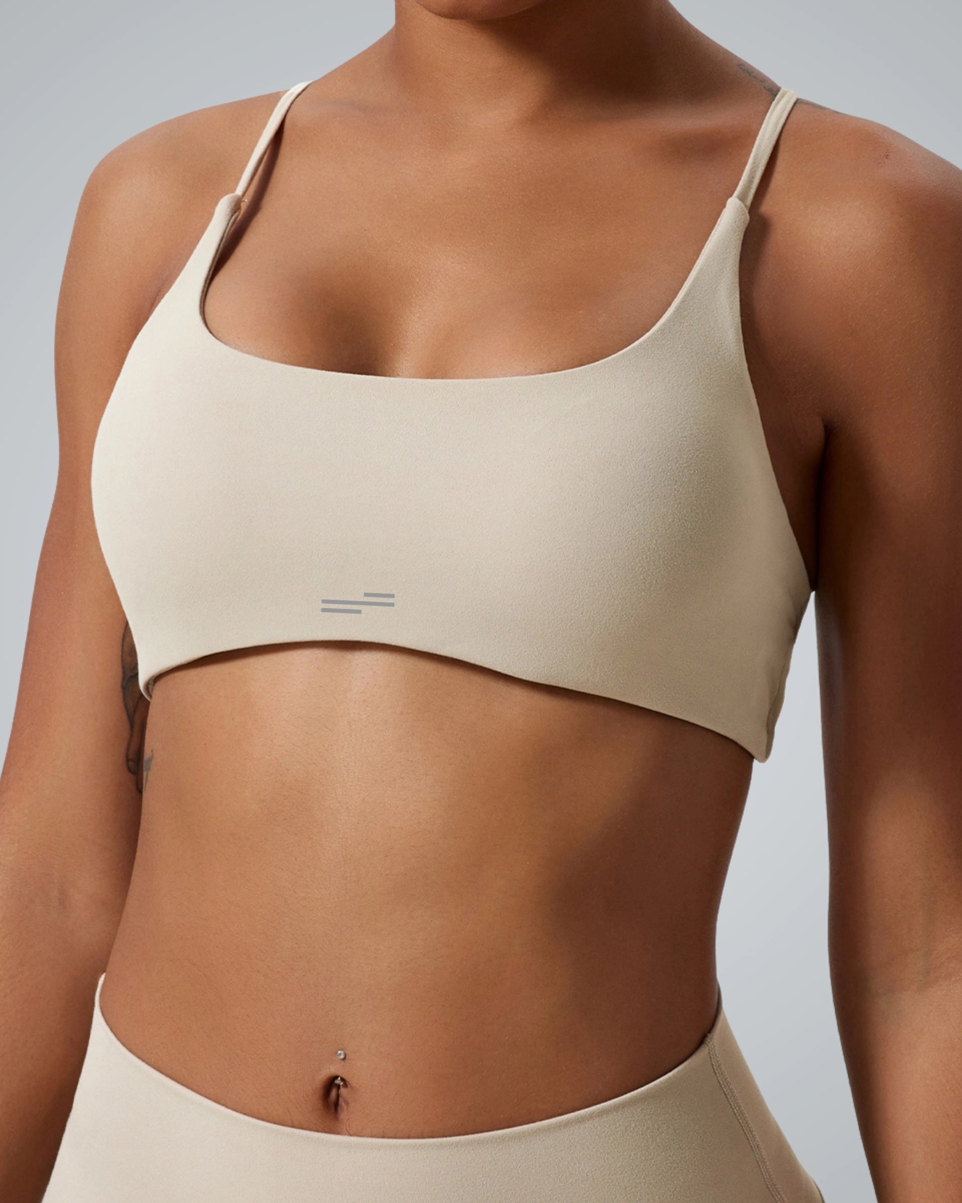 Bandsam Cross Flow Bra for women in soft beige, ideal for yoga and workout. Premium fabric offers stretch and moisture-wicking comfort.