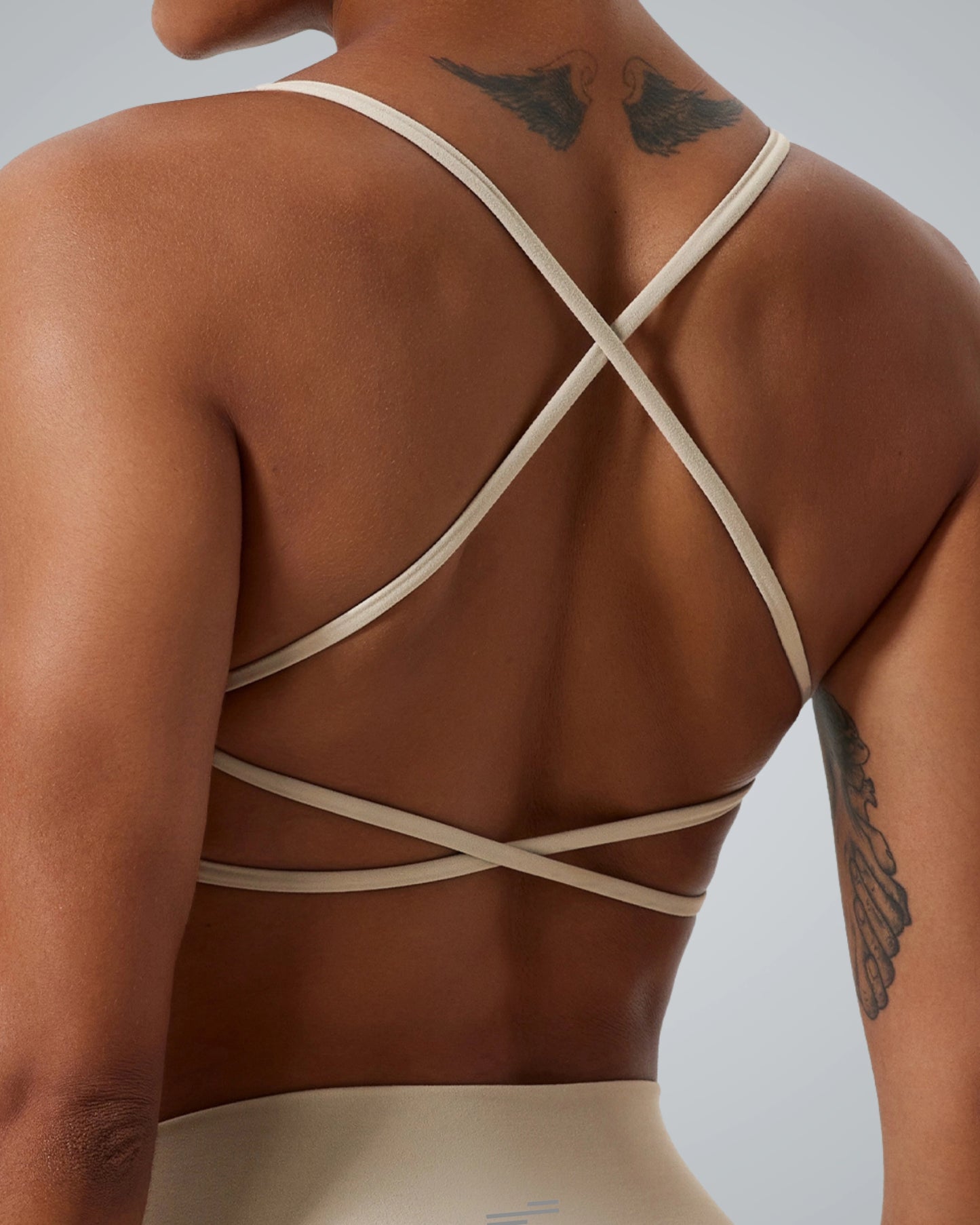 Bandsam Cross Flow Bra in soft, breathable fabric. Ideal for stretch, activewear, workout, and yoga. Back view on woman.