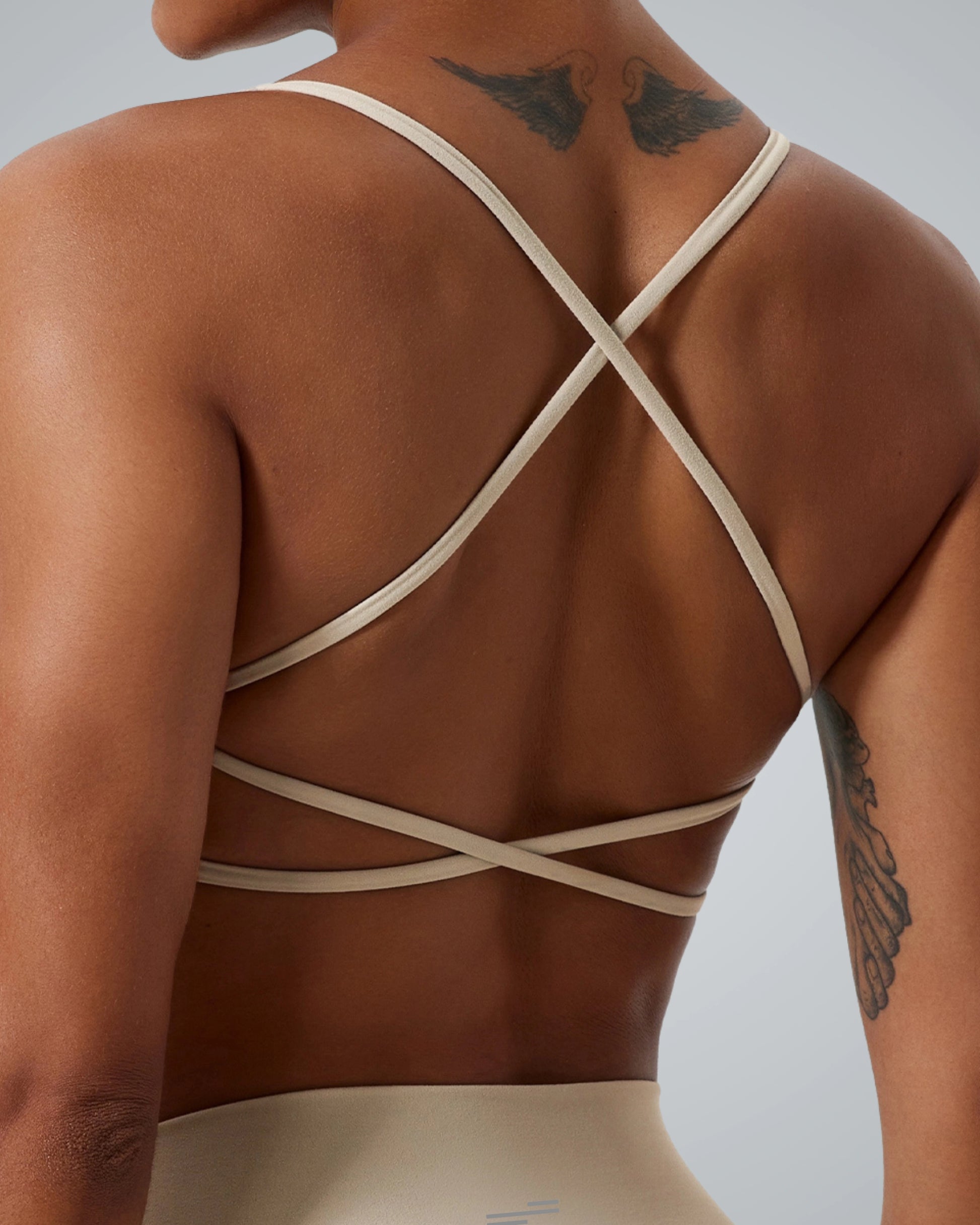 Bandsam Cross Flow Bra in soft, breathable fabric. Ideal for stretch, activewear, workout, and yoga. Back view on woman.
