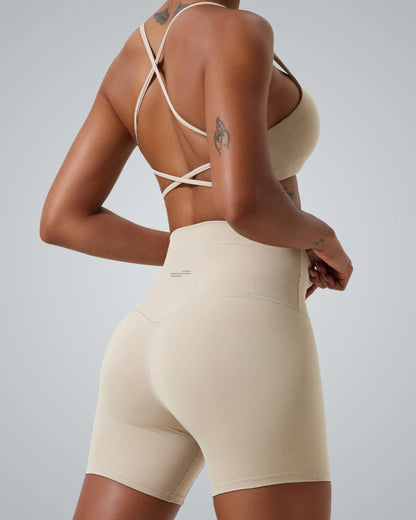 Back view of a woman wearing Bandsam CrossFlow Bra with crisscross straps, perfect for stretch, yoga, and activewear workouts.