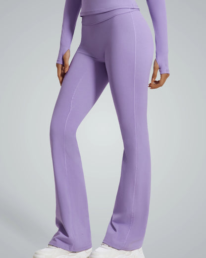 Woman wearing Bandsam CurvAlign Pants in purple, showcasing high-waisted, stretchy activewear ideal for yoga, lounging, and workouts.