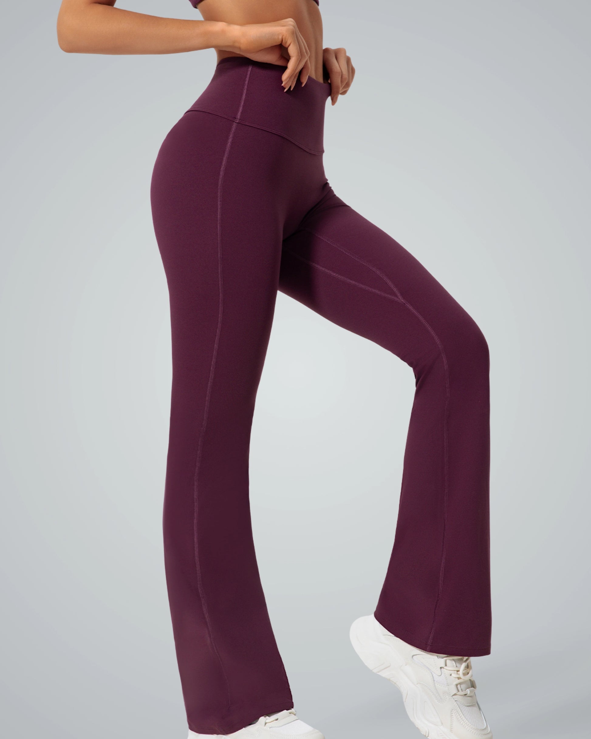 Side view of a woman wearing purple CurvAlign Pants by Bandsam; high-waisted design, perfect for yoga, workout, or lounging.