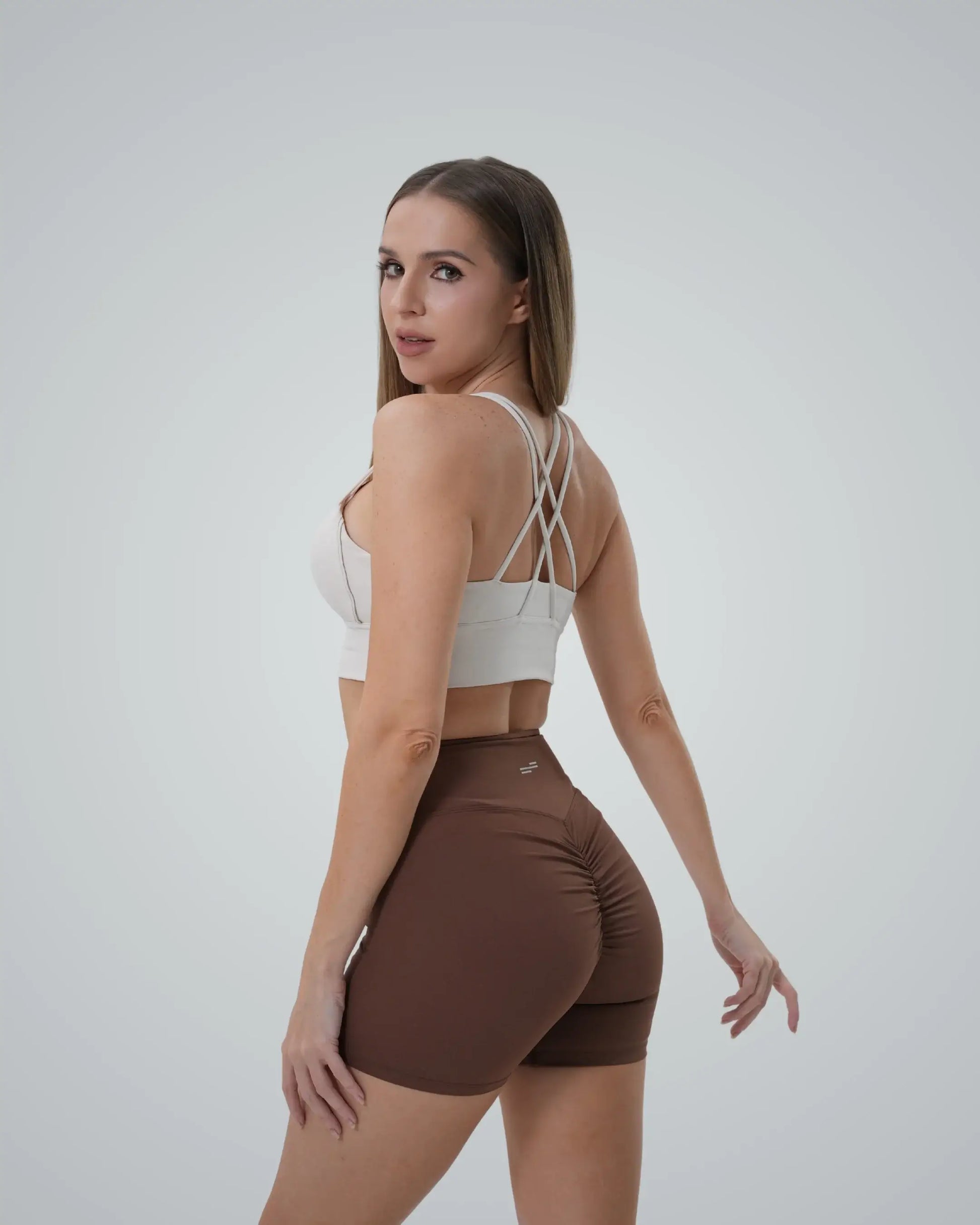 Woman wearing Bandsam Edge Pro Set, a seamless matching workout set with a sports bra and sculpting shorts, minimalist gym wear.