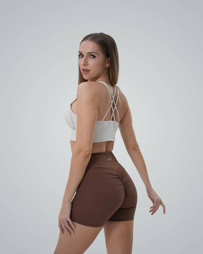 Woman wearing Bandsam Edge Pro Set, a seamless matching workout set with a sports bra and sculpting shorts, minimalist gym wear.