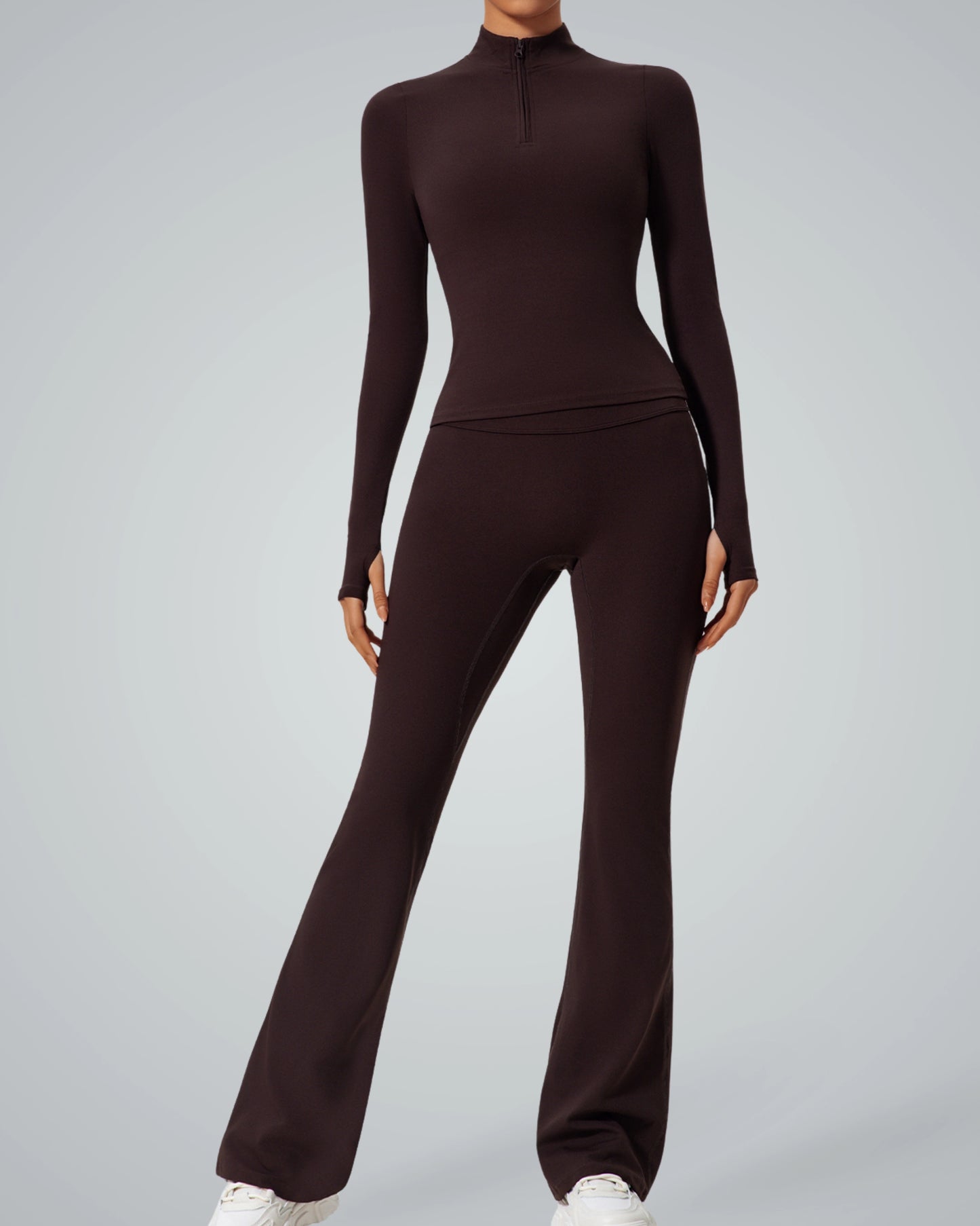 Model wearing Bandsam FluidForce set, featuring a high-neck zip-up and sleek pants; a seamless, sculpting gym outfit for women.