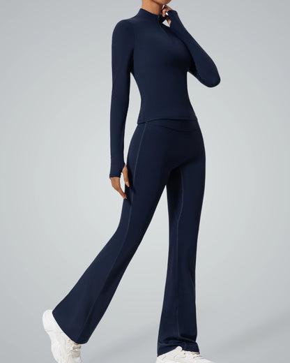 Model wearing Bandsam FluidForce two-piece activewear set with high-neck zip-up and flared leggings for seamless performance and style.