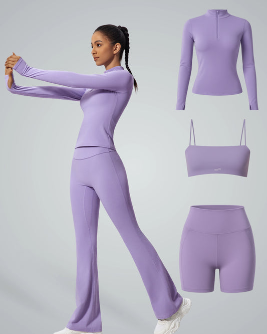 Woman wearing FluidForce Set of 4 by Bandsam, featuring purple high-neck top, sports bra, shorts, and pants for seamless workout style.