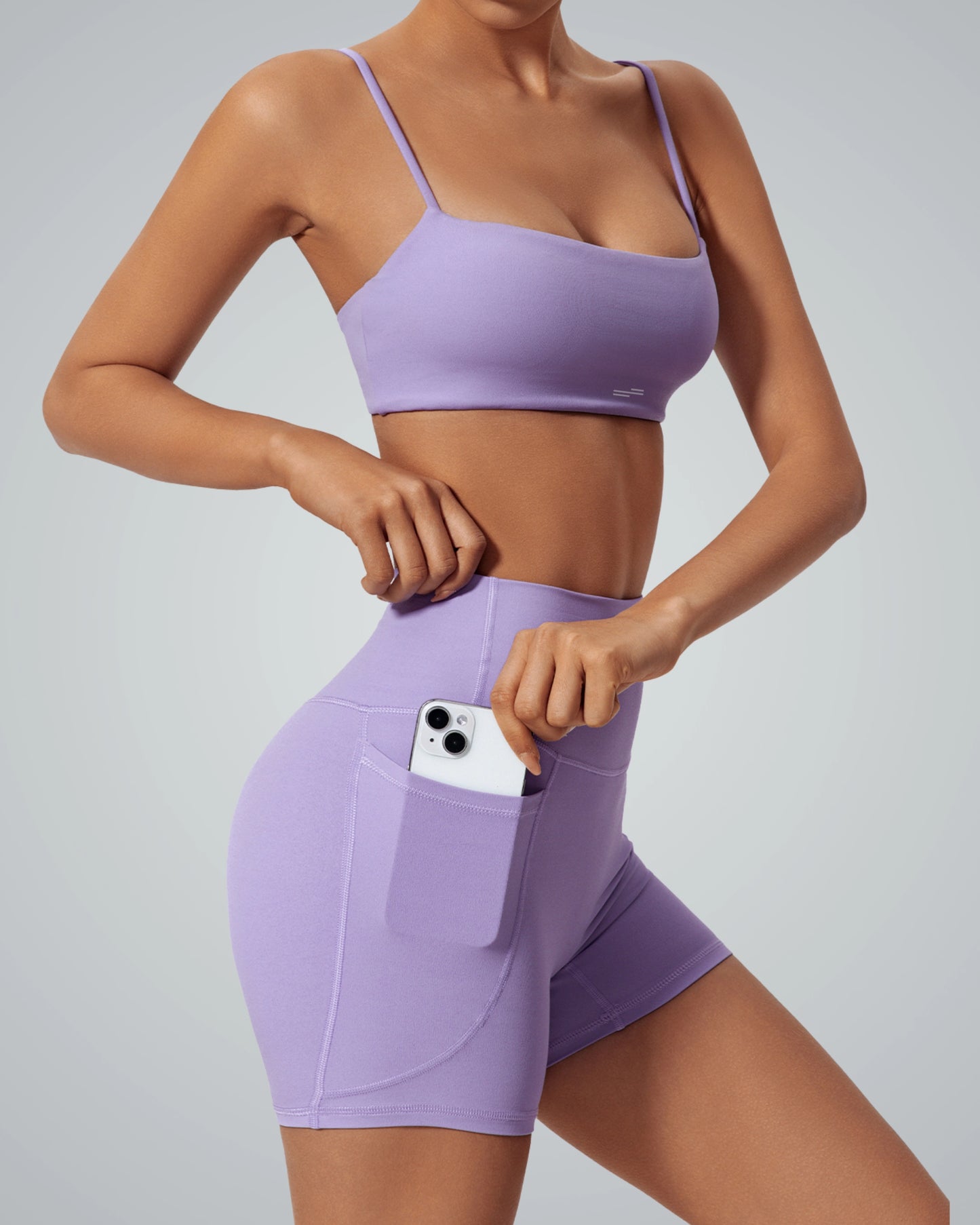 Bandsam FluidForce matching workout set in lavender, featuring a sports bra and high-waisted shorts with a phone pocket; trendy activewear.