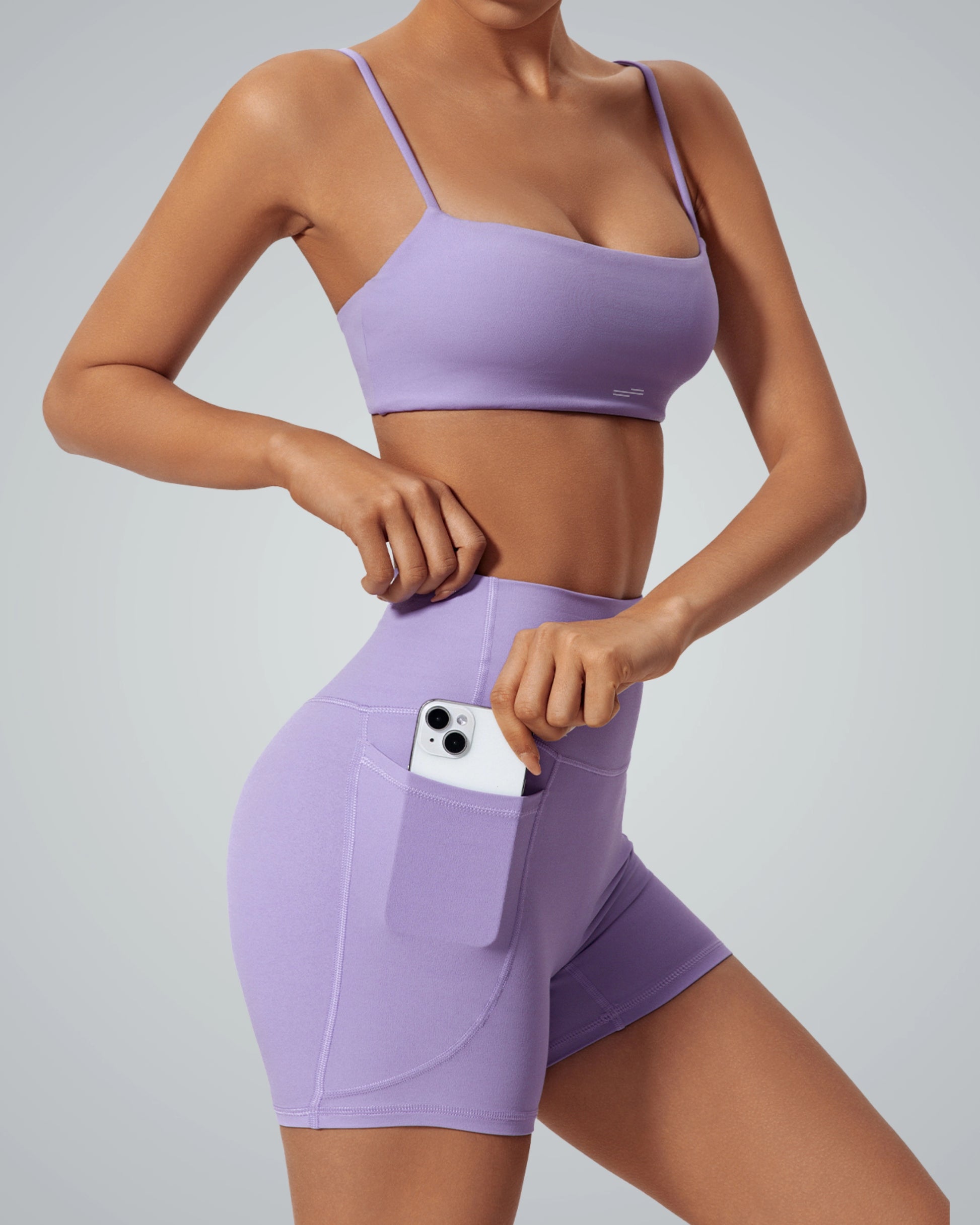 Bandsam FluidForce matching workout set in lavender, featuring a sports bra and high-waisted shorts with a phone pocket; trendy activewear.