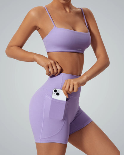 Bandsam FluidForce matching workout set in lavender, featuring a sports bra and high-waisted shorts with a phone pocket; trendy activewear.