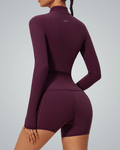 Bandsam FluidForce seamless gym set in bold colorblock, featuring a sleek high-neck zip-up and shorts for a street-style fitness look.