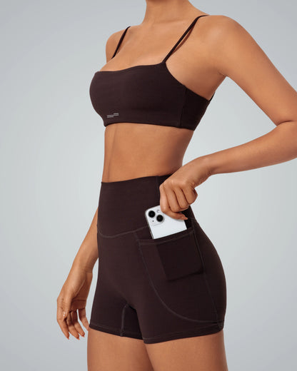 Woman wearing Bandsam GlowLift Bra and shorts, showcasing comfort and flexibility for activewear, yoga, pilates, and relaxation.