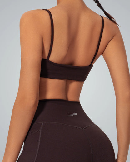 Woman wearing Bandsam GlowLift Bra, showcasing flexible, supportive activewear for comfort and relaxation during yoga, pilates, or outings.