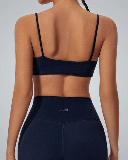 Rear view of woman wearing Bandsam GlowLift Bra, black, designed for comfort, support, and flexibility in yoga, pilates, and lounging.