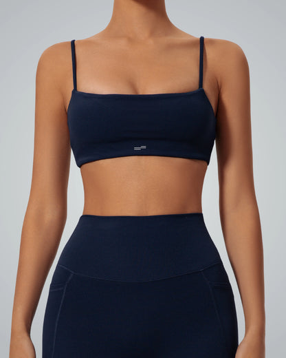 Woman wearing Bandsam GlowLift Bra, a soft, flexible navy bra perfect for activewear, offering comfort and support for yoga or lounging.