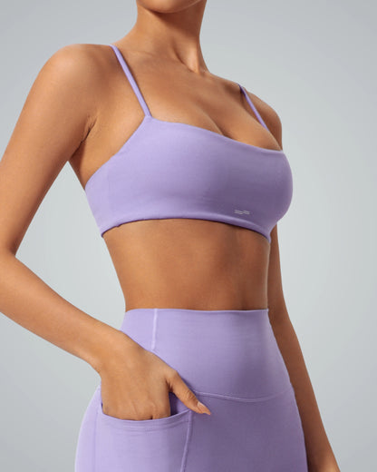 Woman wearing Bandsam GlowLift Bra, showcasing stretch, flexible design ideal for yoga, pilates, activewear, and lounging.