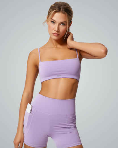 Woman in lilac workout set showcasing Bandsam GlowLift Bra, ideal for yoga, pilates, or lounging. Emphasizes comfort and support.