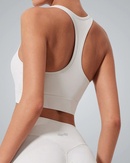 A woman wearing the Bandsam GlowMotion Bra, a light gray high impact sports bra, and matching high-waisted leggings is shown from the back against a neutral background, highlighting both style and support.