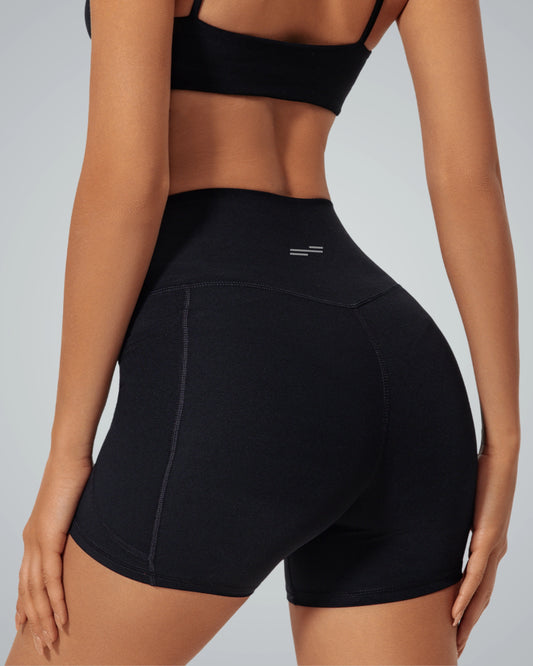 Woman wearing Bandsam LilaFit Shorts, high-rise activewear for yoga, pilates, and workouts. Stretchy, soft, and comfortable black shorts.