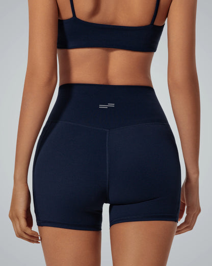 Woman wearing Bandsam LilaFit Shorts in navy, high-rise activewear for comfort and flexibility in yoga, workout, and lounging.