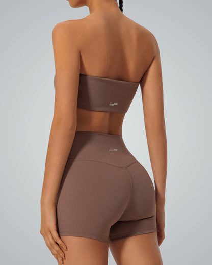 Woman wearing Bandsam LushBreeze Bra and shorts for yoga, showcasing comfort, stretch, and support in brown activewear set.