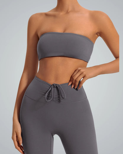 Woman wearing Bandsam LushBreeze Bra, gray strapless bandeau for yoga and lounging, offering comfort and support in soft, flexible fabric.