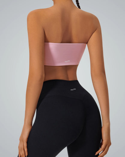 Rear view of woman wearing pink strapless Bandsam LushBreeze Bra and black leggings, ideal for comfort, support, yoga, and activewear.