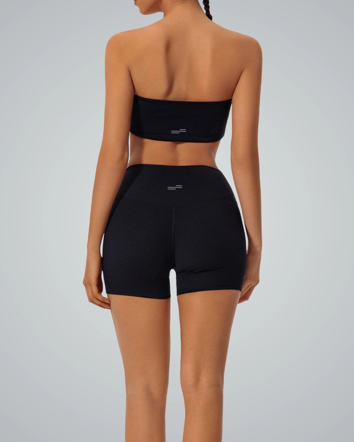 Back view of Bandsam LuxeEase Bandeau Set in black, featuring a seamless gym set with a bandeau top and high-waisted shorts for women.