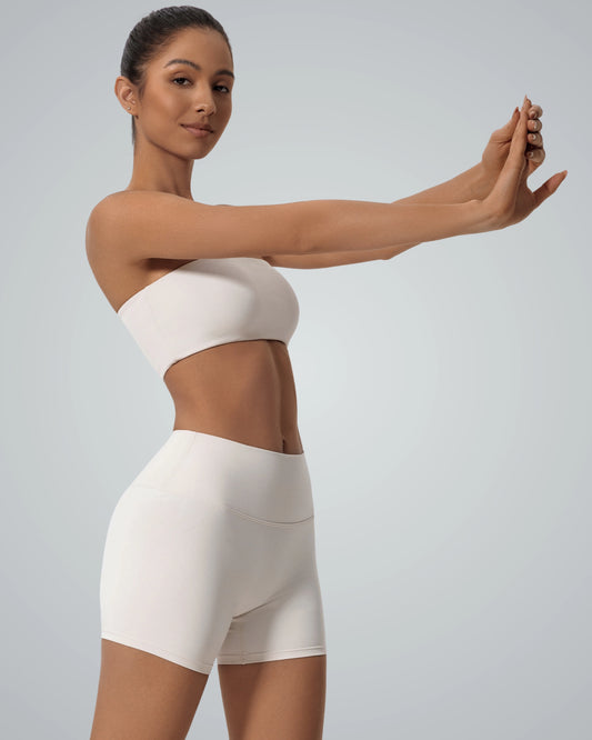 Woman wearing LuxeEase Bandeau Set by Bandsam, a seamless minimalist gym set, perfect for yoga and athleisure, in white.