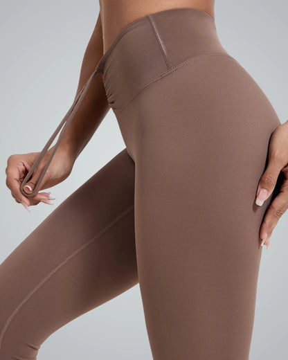 Close-up of high-waisted brown leggings with a drawstring from Bandsam LuxePulse Active Set, part of a seamless gym outfit for women.