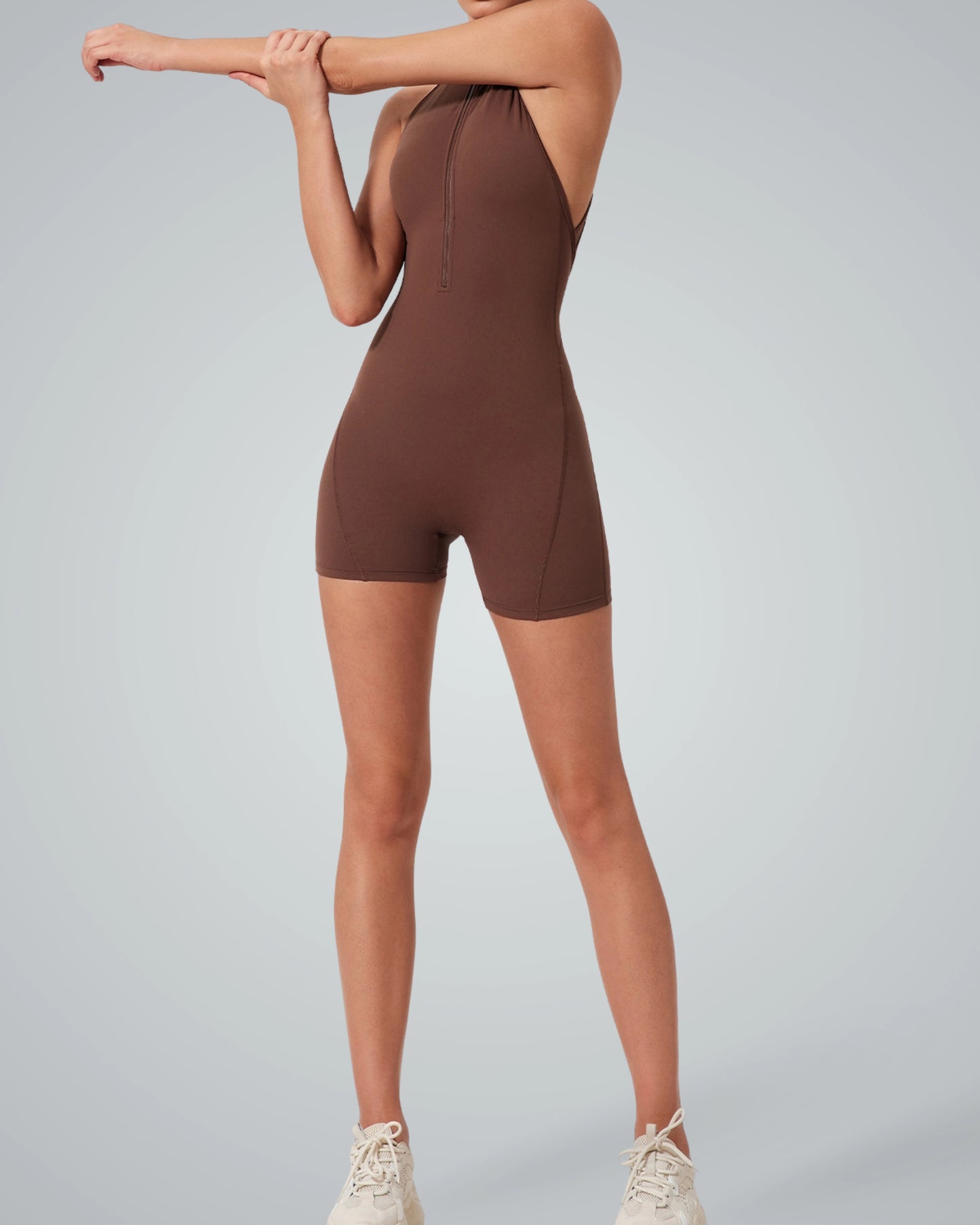 Woman wearing Bandsam Midnight Motion Bodysuit, showcasing stretchy and comfortable sleeveless design for activewear or lounging.